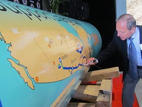 Joe Macinelli, international vice-president of the Labourers' International Union of North America, signs a pipeline display supporting the Energy East pipeline project. He was speaking at a Safe Pipelines Symposium Tuesday in Sarnia. (Paul Morden/Sarnia Observer)
