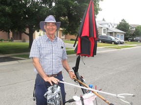 Using his walker and grabbing tools, Robert Charest has spent the last six years cleaning up litter from the streets and trails of the city's east end. He will be receiving a civic award for his effort. (Michael Lea/The Whig-Standard)