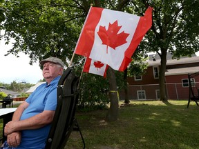 Henry McCambridge sits in front of his home in Ottawa. He's upset that someone stole a number of Canadian Flags at the front of his seniors building in Ottawa.