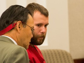 Dereck James Harrison, right, stands with public defender, Ron Fujino in the courtroom at the Farmington, Utah, Courthouse, Monday, May 23, 2016. A father and son accused in a bizarre Utah kidnapping will remain jailed without bail as authorities investigate if they were involved with the death of a rail line worker whose body was found in Wyoming. (Rick Egan/The Salt Lake Tribune via AP, Pool)