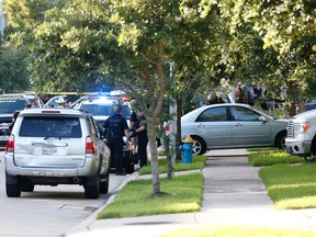 In this Friday, June 24, 2016 photo, Fort Bend County Sheriffs department investigate a shooting at Blanchard Grove and Remson Hollow in Katy, Texas. (Karen Warren/Houston Chronicle via AP)