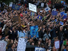 Demonstrators chant and clap on College Green outside The Houses of Parliament at an anti-Brexit protest in central London on June 28, 2016. (AFP PHOTO/JUSTIN TALLIS)