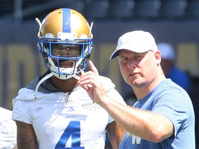 Winnipeg Blue Bombers wide receiver Darvin Adams (l) takes direction from offensive coordinator Paul LaPolice during practice in Winnipeg Tuesday June 28, 2016.