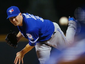 Toronto Blue Jays starter J.A. Happ delivers a pitch to Colorado Rockies' Charlie Blackmon during the first inning of a baseball game Tuesday, June 28, 2016, in Denver. (AP Photo/David Zalubowski)