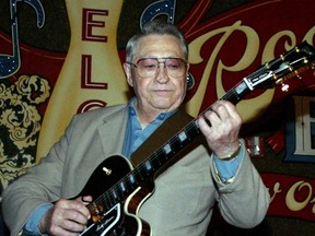 This April 30, 2003, file photo shows Scotty Moore, a former guitarist for Elvis Presley, playing music at the 2nd annual Ponderosa Stomp in New Orleans. (AP Photo/Judi Bottoni, File)