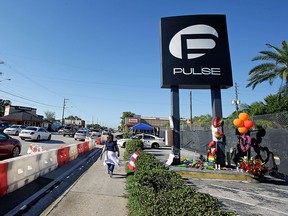 Traffic moves along Orange Ave. after authorities opened the streets around the Pulse nightclub, scene of the recent mass shooting, Wednesday, June 22, 2016, in Orlando, Fla. (AP Photo/John Raoux)