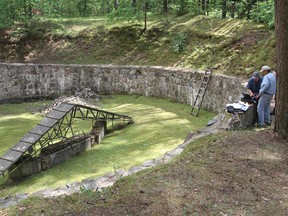 This photograph released by the Israel Antiquities Authority made on Wednesday, June 22, 2016, shows preparation for Electric Resistivity Tomography scan of the pit used to hold the victims before their execution at Ponar massacre site near the town of Vilnius, Lithuania. An international research team has discovered a legendary tunnel that Jewish prisoners secretly dug out with spoons to try to escape their Nazi captors during the Second World War, the Israel Antiquities Authority announced Wednesday. (Ezra Wolfinger/Israel Antiquities Authority via AP)