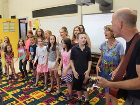 Samantha Reed/The Intelligencer
The College Street Kids sing 'The Streets of London' at College Street Public School Tuesday morning. Students sing alongside Peterborough musician Tom Eastland while he plays guitar and music teacher Susanne Kozol Allin. The group recorded a CD and music videos of nine songs, most of which were written by Eastland.
