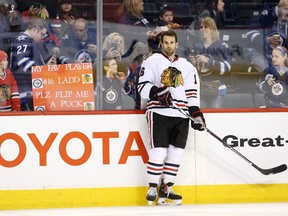 Chicago Blackhawks fans try to get the attention of Blackhawks left winger Andrew Ladd before a game against the Winnipeg Jets at MTS Centre on April 1, 2016. (Bruce Fedyck/USA TODAY Sports)