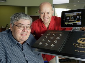 Edmonton sports writer Terry Jones (left) and book publisher Grant Lovig (right) with the new Edmonton Eskimos book on Monday June 27, 2016. The book, Epic Legacies of the Edmonton Eskimos, is the first of its kind in North America, containing interactive layouts and souvenirs unique to each print. It is available for purchase at the Edmonton Eskimos store.