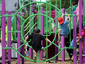 Tim Miller/The Intelligencer
Students from Georges Vanier Catholic School hang out on a play structure in the schoolyard as they enjoy one of the last recesses of the school year on Wednesday.