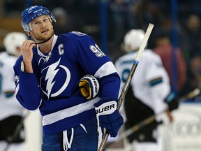Tampa Bay Lightning's Steven Stamkos reacts as members of the San Jose Sharks celebrate a win after an NHL hockey game in Tampa on Feb. 16, 2016. (AP Photo/Mike Carlson)