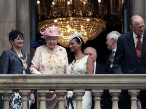 Britain's Queen Elizabeth and Prince Philip smile from the balcony at Liverpool Town Hall, before attending lunch there as part of their visit to the city of Liverpool, England, Wednesday, June 22, 2016. (Peter Byrne/PA via AP)