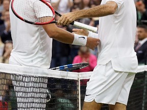 Roger Federer shakes hands with Marcus Willis, left, after beating him in their match at Wimbledon in London, Wednesday, June 29, 2016. (AP Photo/Tim Ireland)