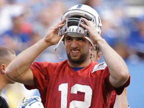 Indianapolis Colts’ Andrew Luck puts on his helmet during a practice, Wednesday, June 8, 2016, in Indianapolis. (AP Photo/Darron Cummings)