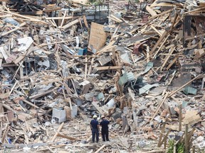 One day after the Mississauga explosion investigators comb through the rubble to try and figure out a cause on Wednesday June 29, 2016. Craig Robertson/Toronto Sun/Postmedia Network