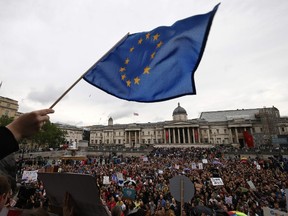 A demonstrator waves a European flag as people gather for an anti-Brexit protest in Trafalgar Square in central London on June 28, 2016. (AFP PHOTO/JUSTIN TALLIS)