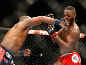 In this Jan. 3, 2015 file photo, Daniel Cormier, left, punches Jon Jones during their light heavyweight title bout at UFC 182, in Las Vegas. (AP Photo/John Locher, File)