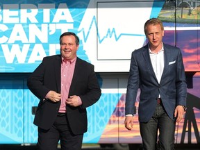 Calgary Conservative MP Jason Kenney arrives at a meeting of Alberta Can't Wait, a group hoping to unite the right in the province, at the Royal Canadian Legion in Cochrane Wednesday June 29, 2016. To his right is Grande Prairie Mackenzie MLA Chris Warkentin. (Ted Rhodes/Postmedia)