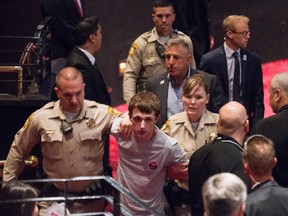 In this photo taken June 18, 2016, police remove Michael Steven Sandford as Republican presidential candidate Donald Trump speaks at the Treasure Island hotel and casino in Las Vegas. (Erik Verduzco/Las Vegas Review-Journal via AP)