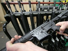 In this April 10, 2013 file photo, a newly-assembled AR-15 rifle is shown at the Stag Arms company in New Britain, Conn. A suburban Chicago gun shop is raffling an AR-16 rifle to benefit victims of the nightclub shooting in Orlando. (THE CANADIAN PRESSS/AP/Charles Krupa)