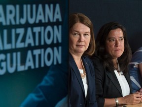 Minister of Health Jane Philpott and Minister of Justice and Attorney General of Canada Jody Wilson-Raybould (right) are seen during a news conference in Ottawa, Thursday June 30, 2016. THE CANADIAN PRESS/Adrian Wyld