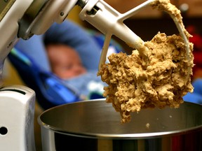 In this undated file photo, cookie dough clings to the beaters of a standing mixer. The Food and Drug Administration issued a warning on June 28, 2016, that people shouldn't eat raw dough due to an ongoing outbreak of illnesses related to a strain of E. coli bacteria found in some batches of flour.  (AP Photo/Larry Crowe, File)