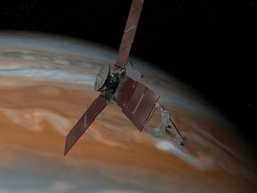 This artist's rendering provided by NASA and JPL-Caltech shows the Juno spacecraft above the planet Jupiter. Five years after its launch from Earth, Juno is scheduled to go into orbit around the gas giant on Monday, July 4, 2016. (NASA/JPL-Caltech via AP)