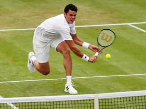 Milos Raonic returns to Andreas Seppi during their match at the Wimbledon Tennis Championships in London on Thursday, June 30, 2016. (Ben Curtis/AP Photo)