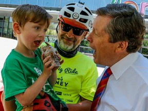 John Tory pretends to take a bite of Max's ice-cream sandwich. Toronto mayor John Tory was on hand at Sugar Beach at the Queens Quay and Jarvis St. to meet 5 year old Max Sedmihradsky and his father Andrew who stopped in Toronto on there 600 km. bike trip from Ottawa to Hamilton to raise funds to help cure Duchenne muscular dystrophy via the charity Jesse's Journey on Thursday June 30, 2016. Dave Thomas/Toronto Sun/Postmedia Network