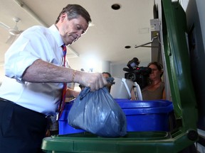 Mayor John Tory making use of the green bin for city recycling in Toronto on Thursday June 30, 2016. Dave Abel/Toronto Sun/Postmedia Network