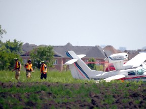 Emergency crews on scene after a plane crash landed in a field West of the 404 south of Elgin Mills Rd East on Thursday June 30, 2016. Dave Abel/Toronto Sun/Postmedia Network
