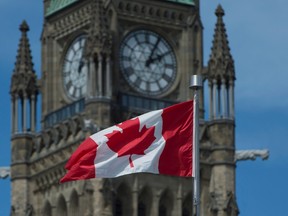 The Maple Leaf flies in front of the Peace tower on Parliament Hill Friday May 6, 2016 in Ottawa. THE CANADIAN PRESS/Adrian Wyld