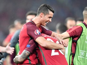 Portugal’s Cristiano Ronaldo celebrates with teammate Ricardo Quaresma after winning the Euro 2016 quarterfinal against Poland at the Velodrome stadium in Marseille, France, Thursday, June 30, 2016. (AP Photo/Martin Meissner)