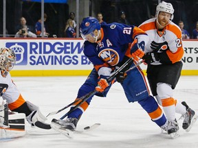 Philadelphia Flyers goalie Steve Mason stops a shot by New York Islanders forward Kyle Okposo (21) in New York, Monday, March 21, 2016. (AP Photo/Kathy Willens)