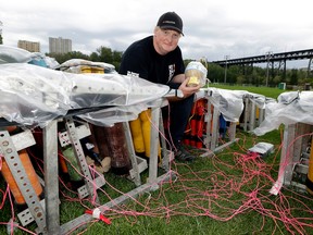 Brad Dezotell (President, Fireworks Spectaculars) prepares the fireworks mortar racks on Thursday June 30, 2016 for the fireworks display at Kinsmen Park in downtown Edmonton on Canada Day. LARRY WONG/Postmedia Network