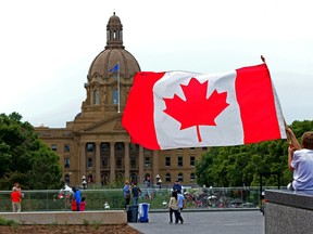 Happy 148th Birthday Canada! A very patriotic Owen Dorward holds a Canadian Flag on Canada Day on the Alberta Legislature grounds on July 1st, 2015.