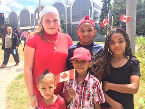 Sue-Ellen Salmon and her four children are excited to watch their father take his oath of citizenship during an annual citizenship ceremony at the Canada Day celebrations at Harris Park. (HALA GHONAIM/THE LONDON FREE PRESS)