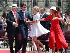 Governor General David Johnston, left to right, Prime Minister Justin Trudeau, Minister of Canadian Heritage Melanie Joly and Sophie Gregoire Trudeau dance during the noon hour entertainment during Canada Day celebrations on Parliament Hill, in Ottawa on Friday, July 1, 2016. THE CANADIAN PRESS/Justin Tang