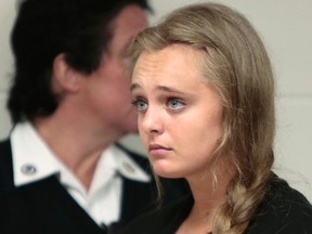 In this Aug. 24, 2015 file photo, Michelle Carter listens to defense attorney Joseph P. Cataldo argue for an involuntary manslaughter charge against her to be dismissed at Juvenile Court in New Bedford, Mass. Carter, of Plainville, Mass., is charged with involuntary manslaughter for allegedly pressuring Conrad Roy III, of Fairhaven, Mass., to commit suicide in 2014.  (Peter Pereira/Standard Times via AP, Pool, File)
