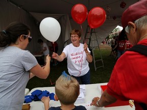 Emily Mountney-Lessard/The Intelligencer
Volunteer and Belleville resident Rose Marie Hamilton hands out balloons during Canada Day celebrations on Friday in Belleville.