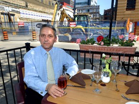 Jerry Pribil, owner of the Marienbad restaurant, shows the view from the patio of his Carling Street restaurant beside the ongoing construction on the new Fanshawe College building. (London Free Press file photo)