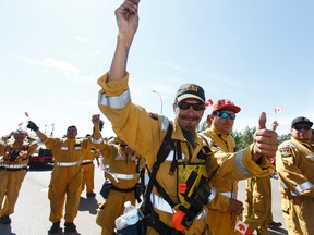 Wildland firefighters march in the Canada Day parade held in Fort McMurray on Friday, July 1, 2016. Ian Kucerak / Postmedia