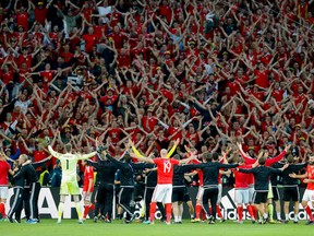 Wales' players celebrate with fans their 3-1 win at the end of the Euro 2016 quarterfinal soccer match between Wales and Belgium, at the Pierre Mauroy stadium in Villeneuve d?Ascq, near Lille, France, Friday, July 1, 2016. (AP Photo/ Michel Spingler)