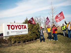 Representatives from Unifor stood outside the Toyota plant in Cambridge on March 31, 2014, as part of an ongoing union drive. Organizers have since toned down their actions at the gate, switiching their focus to a quieter drive inside the Woodstock and Cambridge plants. (REUTERS/Mark Blinch file photo)