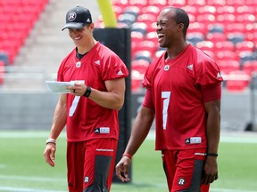 Quarterback Henry Burris, who suffered an injury to his pinky finger in the Redblacks’ game against Edmonton, jokes with backup QB Trevor Harris during practice at TD Place Monday, June 27, 2016. (JULIE OLIVER/POSTMEDIA)