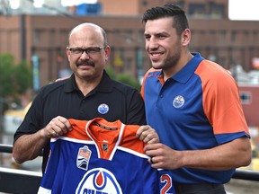 Newly acquired forward, Oiler Milan Lucic and GM Peter Chiarelli before talking to the media in Edmonton, Friday, July 1, 2016.