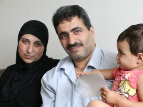 Wael Aun and his wife, Wafaa Aon and their two-year-old daughter, Mariam in their new Ottawa apartment.