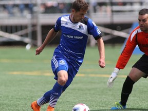 FC Edmonton forward Jake Keegan takes the ball in on Fort Lauderdale Strikers keeper Diego Restrepo during the Eddies 2-1 victory Sunday, June 12, 2016 at Clarke Park in Edmonton, Alta.