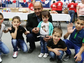John Lappa/The Sudbury Star
Khalaf Alramadan and his family attended the Sudbury Multicultural and Folk Arts Association Canada Day celebrations Friday at the Sudbury Community Arena and even posed for a photo for The Sudbury Star. They arrived only on Thursday.
